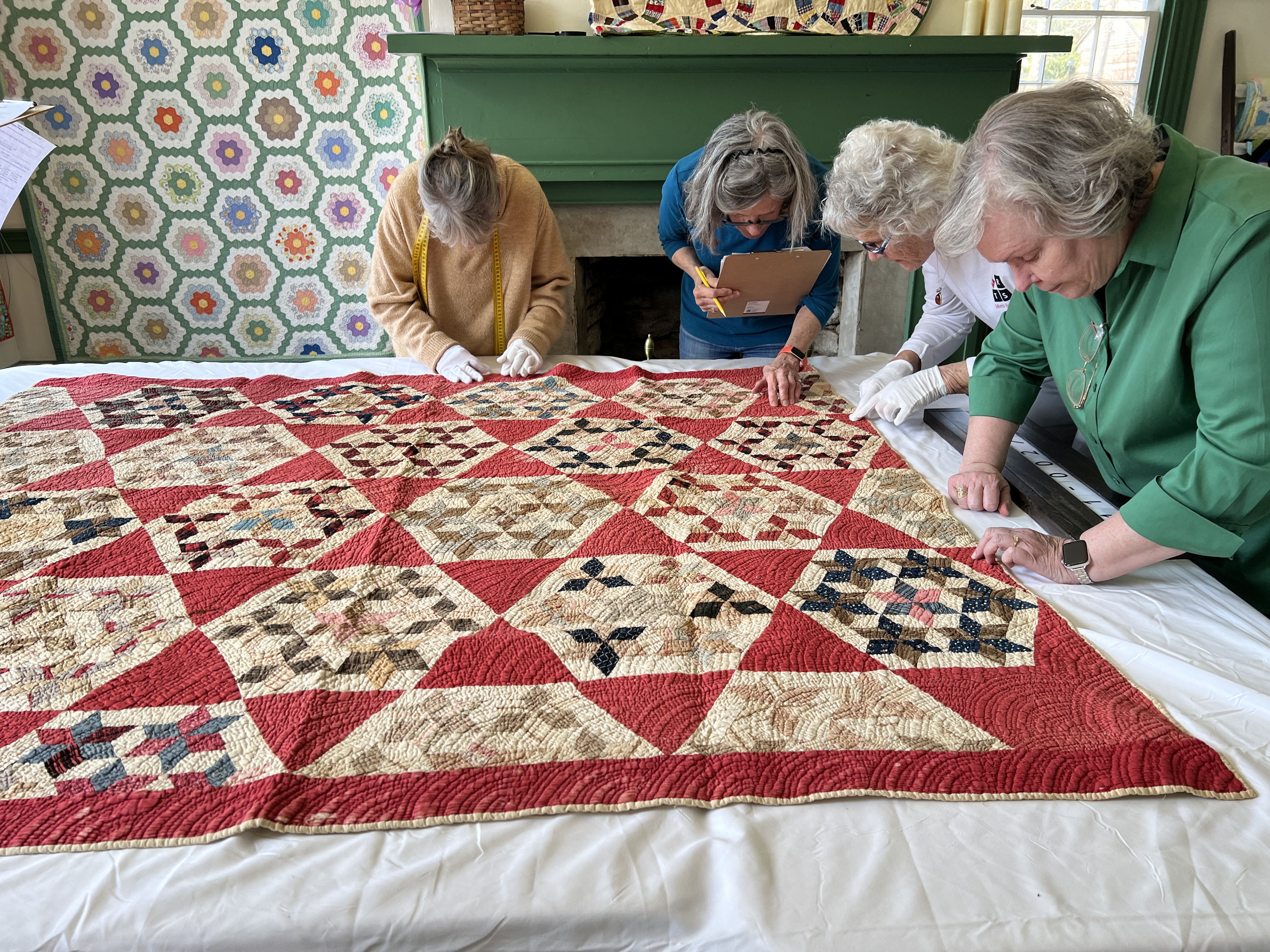 group gathered around a quilt